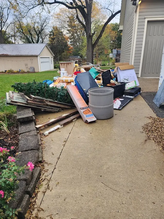 Dumpster being loaded with debris for Residential Dumpster Rental in Northwood